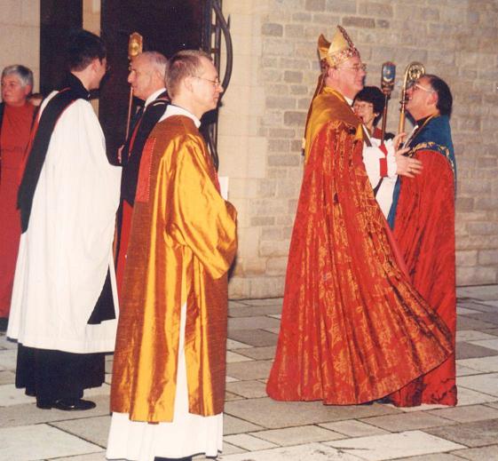 David is congratulated by the bishop after the ceremony