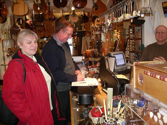 John signs a Peeping Tom tune book in Lark in the Morning